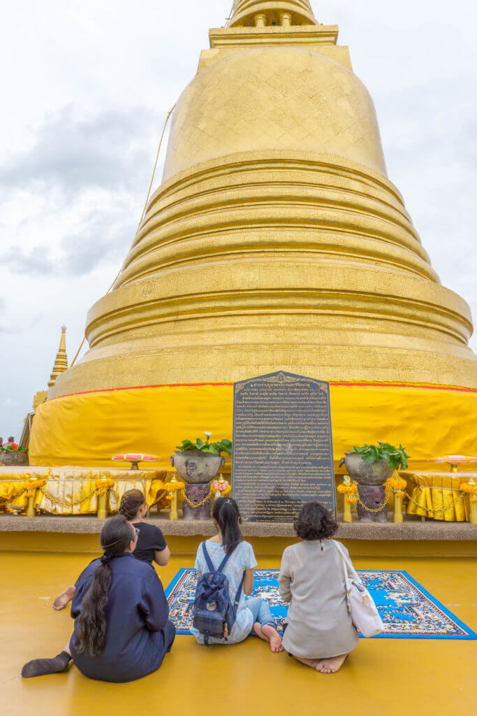 people praying at Golden Mount temple - Bangkok 4 days itinerary for 1st timers