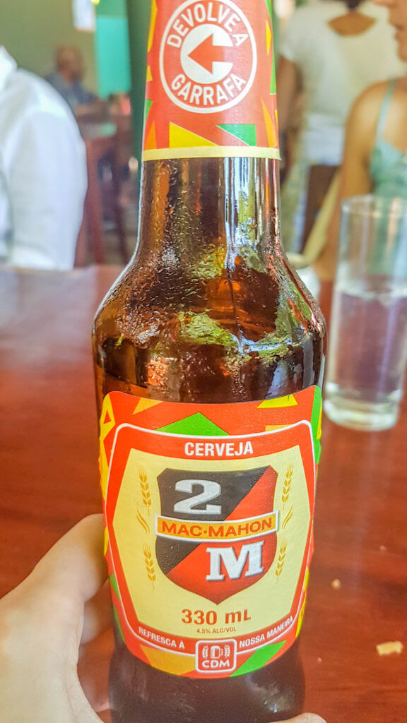 tasting the local beer in Mozambique