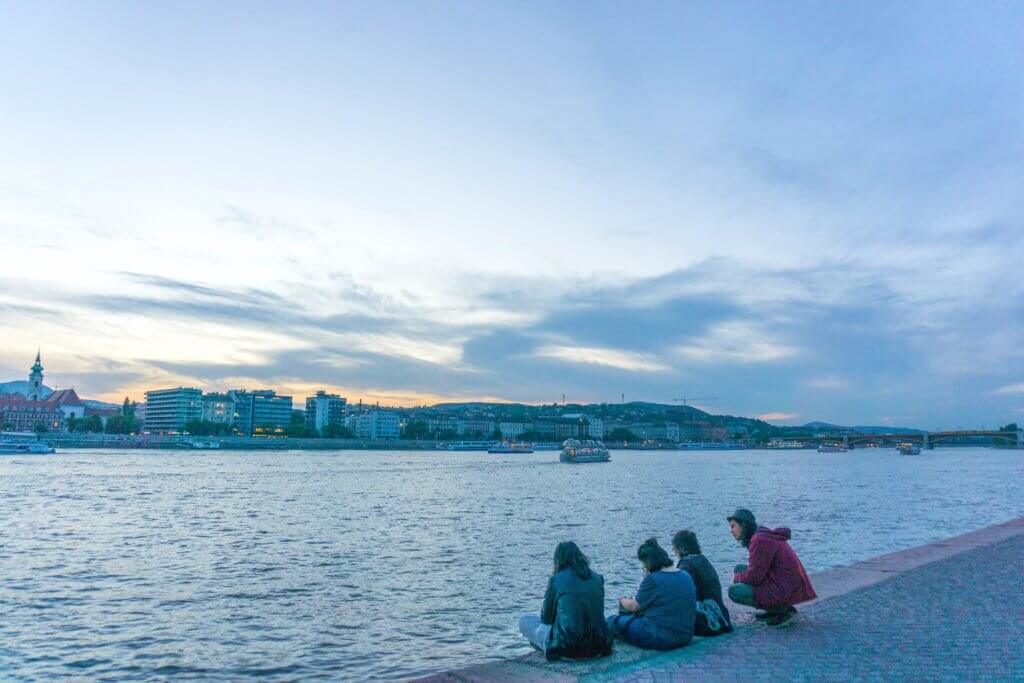 things to see in Budapest - people sitting on the Danube promenade