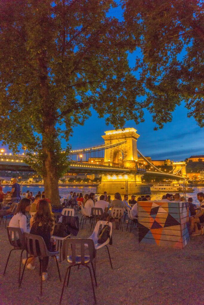 Budapest 4 day travel itinerary - people sitting on a cafe next to Chain Bridge