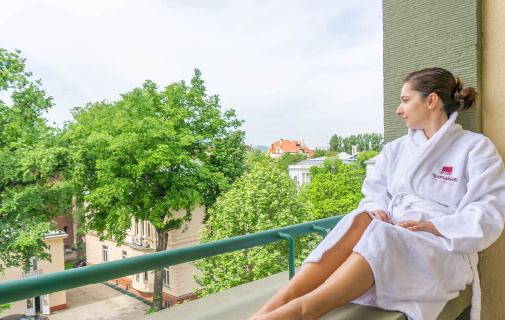 where to stay in Budapest: me in our balcony at Mamaison Hotel Andrassy