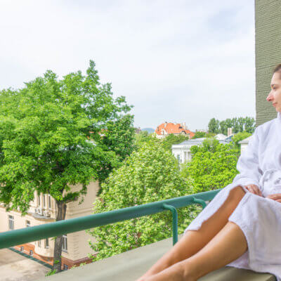 where to stay in Budapest: me in our balcony at Mamaison Hotel Andrassy