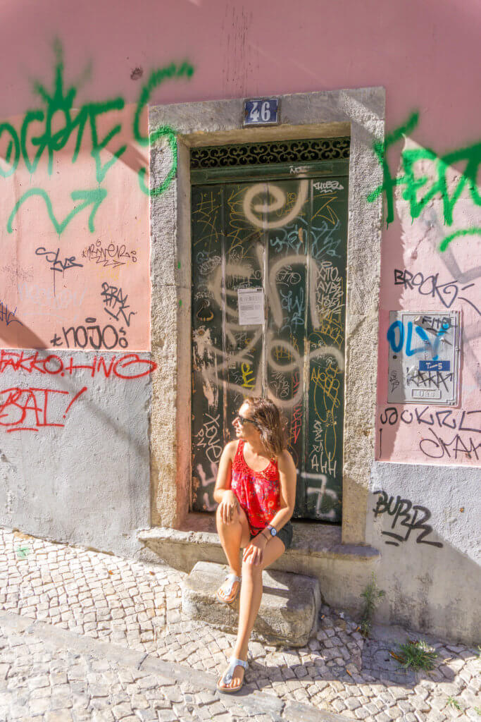 Sitting in a doorstep in Bairro Alto, Lisbon | 2 week Portugal itinerary