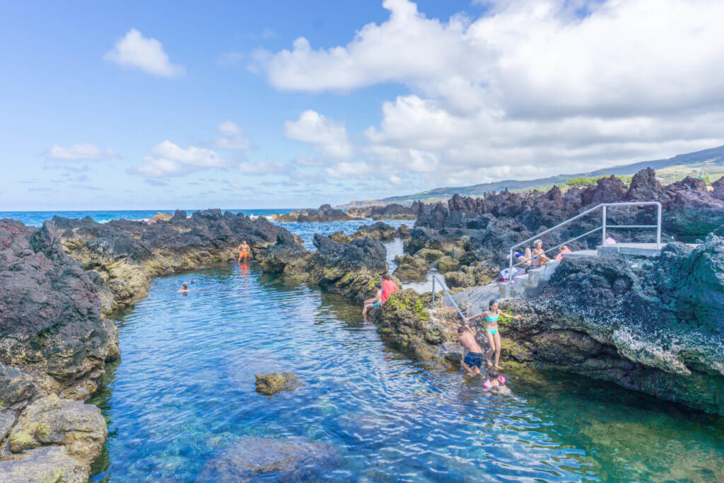 People swimming in Biscoitos, Terceira Island, Azores | Portugal off the beaten path: 2 weeks in Portugal itinerary by a local 