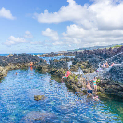 People swimming in Biscoitos, Terceira Island, Azores | Portugal off the beaten path: 2 weeks in Portugal itinerary by a local