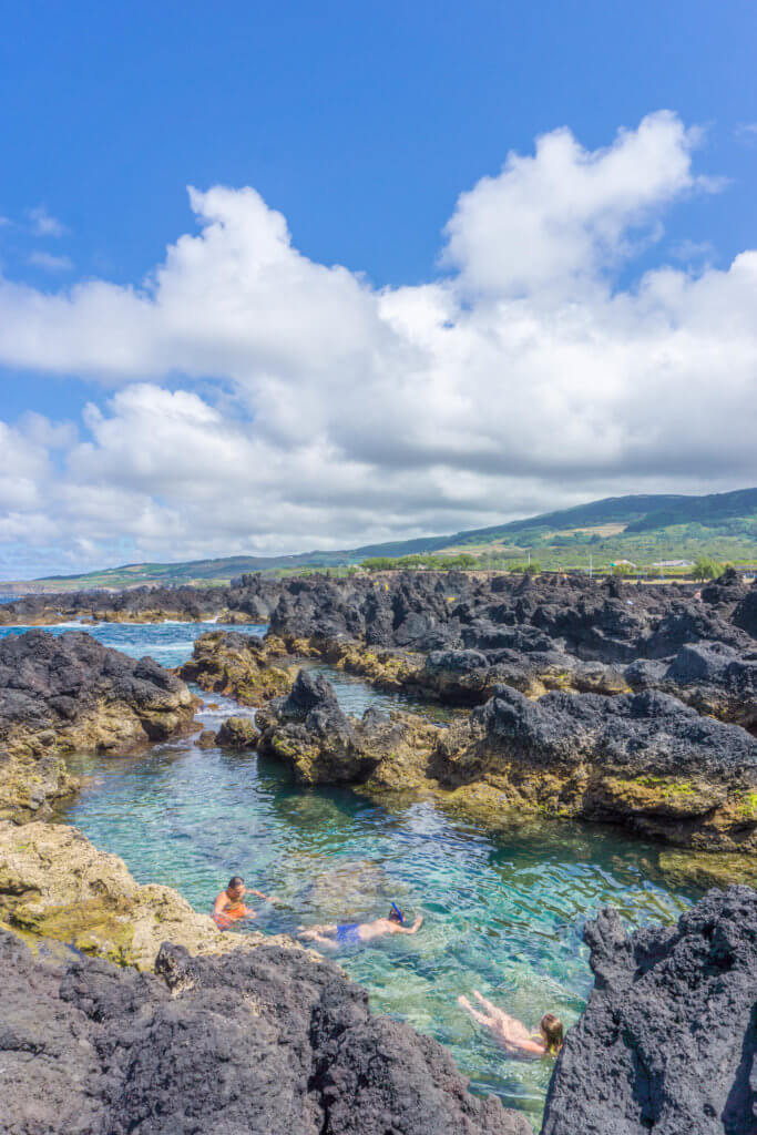 People swimming in Biscoitos, Terceira Island, Azores | Portugal off the beaten path: 2 weeks in Portugal itinerary by a local 