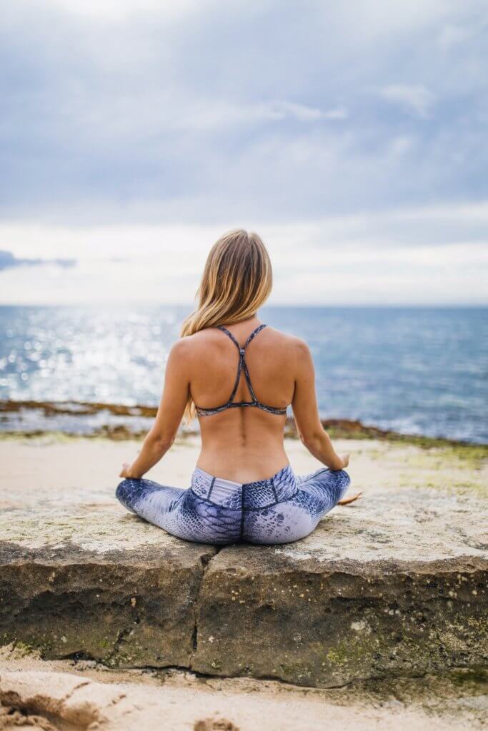 woman practicing yoga by the sea - Greek yoga retreat