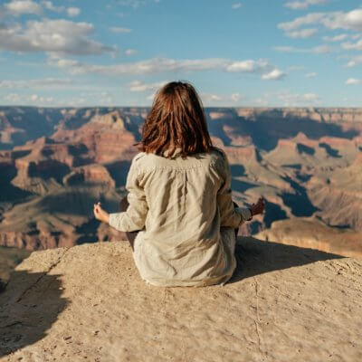 woman meditating at the Grand Canyon - yoga retreats in Arizona