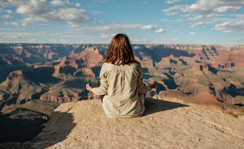 woman meditating at the Grand Canyon - yoga retreats in Arizona